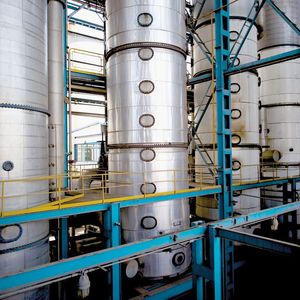 Fermented sugar-cane juice flows through a series of distillation columns to produce ethanol. 