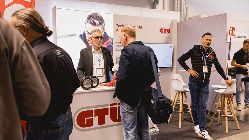 Danach ging es zurück in die Ausstellunghalle – z.B. an den Stand der GTÜ. Hier tauscht sich Wolfgang Henning (li.) mit »kfz-betrieb«-Redakteur Steffen Dominisky aus.  (Bild: Stefan Bausewein)