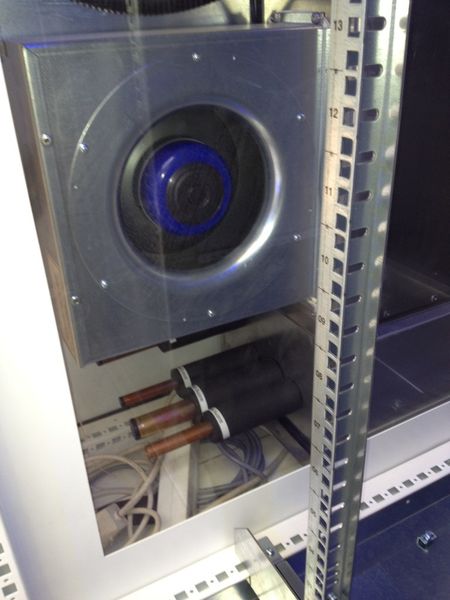 Der neue Seitenkühühler von Schäfer IT Systems in Halle 11, Stand D27: Zu sehen sind unterschiedlich dicke Leitungen für die Kühlung, die dickere kann Wasser führen, das in der Regel mit einer freien Kühlung verbunden wird. Falls die Temperatur im Sommer zu hoch steigt, kann das System auch mit Kühlflüssigkeit die Temperatur im Rack senken. (Bild: SDC)