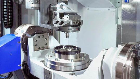 A pallet carrying a machined component being returned automatically from the Brother Speedio U500Xd2-100T to one of the 30 positions in the Erowa Robot Compact 80 storage system.(Source:  Whitehouse Machine Tools)
