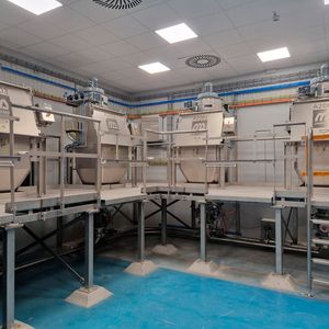 Dinnissen supplied a complete process line with bag emptying systems, rotary valves, pneumatic conveying, receiving hoppers, vibrating sieves, magnets, central dust extraction, platforms, a Big Bag filling station and a 3,000-liter Pegasus Mixer with retractable mixing shafts.  (Source: Dinnissen)