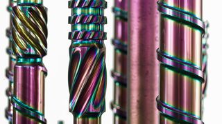 What shines here so rainbow-like are extruder screws coated with the PVD coating Balinit Croma Plus. This system significantly increases wear resistance and is harder than hard chrome plating—and even easier to apply. (Image:Oerlikon Balzers)