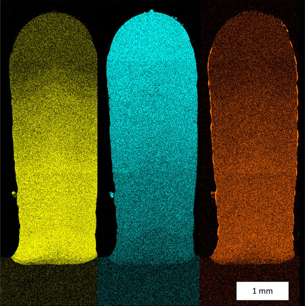Werkstoffexperten des Fraunhofer IWS entwickeln Multi-Material-Bauteile, an denen sie den Materialübergang analysieren. Die Farben zeigen den Übergang: Gelb: Kobalt, blau: Nickel, orange: Aluminium. (Fraunhofer IWS)