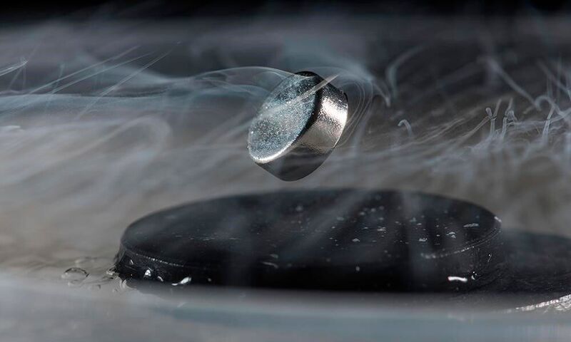 Currently, extreme cold is required to achieve superconductivity, as seen in the above photo from Dias’s lab. In the photo, a magnet can be seen floating above a superconductor cooled with liquid nitrogen. (Adam Fenster, University of Rochester)