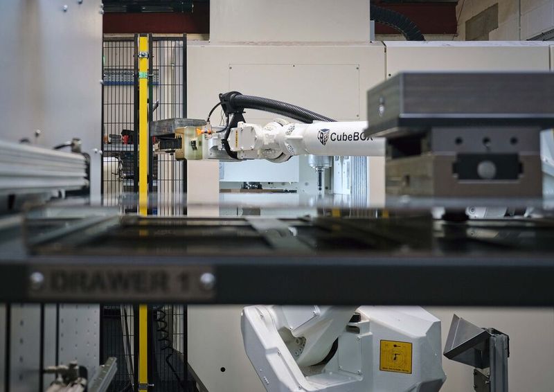 An image of the robot, taken through the aperture above the second drawer, showing the billet nearing the VMC. (Source: Whitehouse Machine Tools )