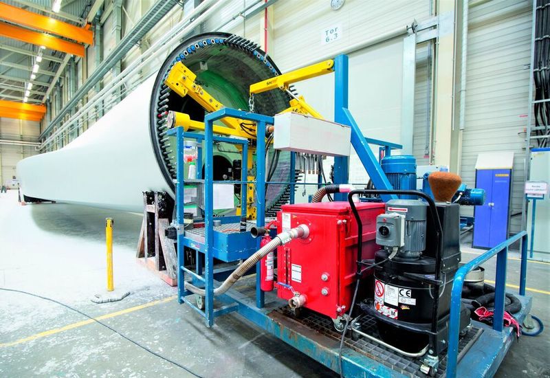 Hier werden die Buchsen mit Gewinden in die Rotorblätter einsetzt, damit das Blatt mit der Nabe verschraubt werden kann – das erfolgt mal automatisiert. Hier ist ein saugstarkes, mobiles Systemduo mit Ruwac-Staub-Ex-Sauger nebst Nassabscheider für die Funken zu sehen.  (Ruwac)