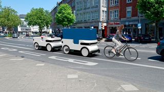 Der Zug folgt einem Mitarbeiter in den Zustellbezirk, dann vereinzeln sich die „Ducks“ und liefern ihre Waren autonom aus.  (Droid Drive)