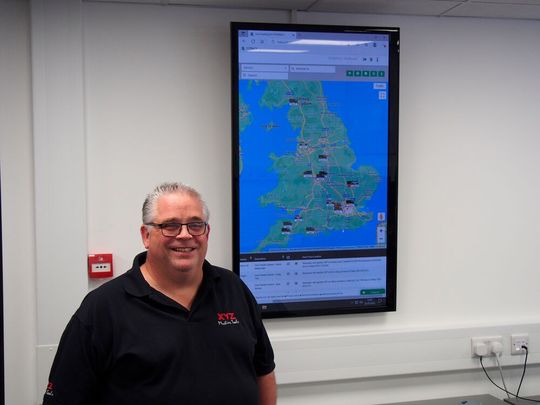 Neil Andrews, Service Team Leader, in front of Live Service Van Tracking Screen Neil Andrews, Service Team Leader, in front of Live Service Van Tracking Screen