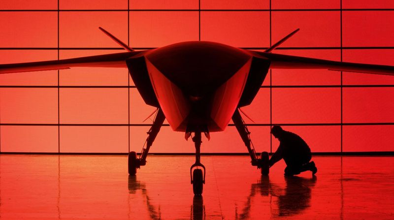 A technician works beside the full-scale design study of Helsing’s CA-1 Europa autonomous uncrewed combat aircraft. Helsing, the European defense AI company, has raised US$1.8 billion in Series E funding, raising its valuation to US$18 billion. (Source: Helsing SE)