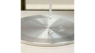 Leidenfrost effect makes water droplets on a hot plate hover over the surface instead of making physical contact with it. (Mikko Raskinen/Aalto University)