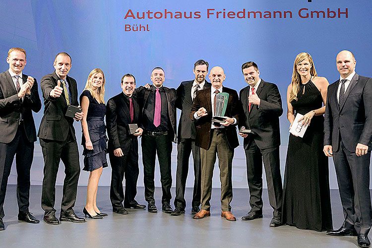 Christian Bauer, Leiter Service Deutschland (li.), und Markus Siebrecht, Leiter Vertrieb After Sales (re.) überreichten im Namen der Audi AG den Siegerpokal an die deutschen Servicemeister. Geleitet wurde die Verleihung von Verena Wriedt (2. v. re.), Moderatorin von „PS - das Automagazin“ auf Vox. (Foto: Audi)