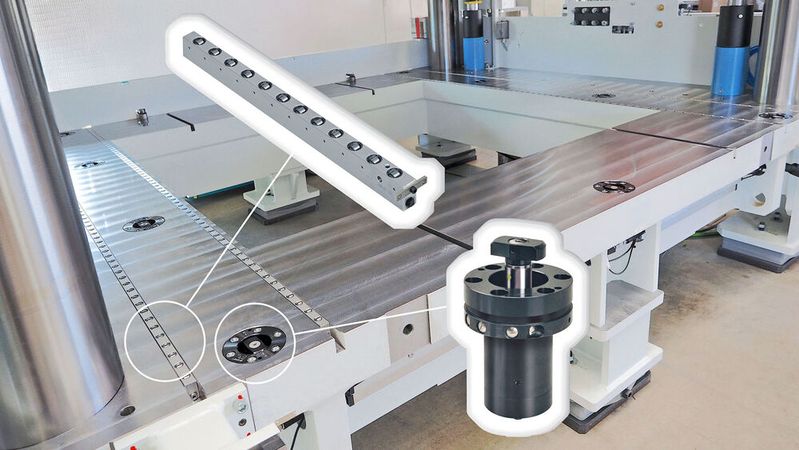 Roemheld double-acting, hydraulically-actuated, swivelling clamping elements are set into the press table to secure the lower half of the trimming die. The clamp design results in interference-free insertion and removal of the heavy dies, assisted by the integration of Roemheld transport rails.(Source:  Stephan Auch/ Roemheld)