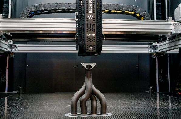 Ein 3D-Drucker bei der Arbeit an einer Art Abgaskrümmer respektive Medienverteilersystem. Das ist wieder so ein komplexes Teil, das in der Rüstung seinen Einsatz findet, weshalb die Mesago Messe Frankfurt der Formnext erstmals einen Defence-Bereich gibt. (Bild: Mesago)