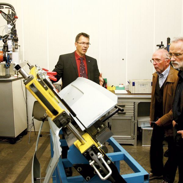 Erlas-Mitarbeiter Dr. Armin Gropp erläutert Gästen der Vernissage die Einrichtungen der Lohnfertigung, im Bild zum Laserstrahllöten von Heckdeckeln an Automobilen. (Archiv: Vogel Business Media)