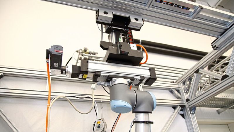 Eine Rotations- und Linearachse von RK Rose+Krieger ermöglicht hier eine Unabhängigkeit der Rotation des Roboters von den Winkelgrenzen des Roboter-Basisgelenks, der Rotationsmittelpunkt wird aus der vertikalen Achse des Portals verschoben. Eine Rotations- und Linearachse von RK Rose+Krieger ermöglicht hier eine Unabhängigkeit der Rotation des Roboters von den Winkelgrenzen des Roboter-Basisgelenks, der Rotationsmittelpunkt wird aus der vertikalen Achse des Portals verschoben.