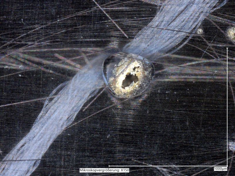 Mikroskopisch klein, aber teuer: Unerwünschte Lufteinschlüsse wie diese in einem Carbon-Bauteil sollen sich dank der mit dem Peter-Dornier-Stiftungspreis 2026 ausgezeichneten Prozesssteuerung künftig um bis zu 87,5 Prozent reduzieren lassen. (Bild: TU Ilmenau)
