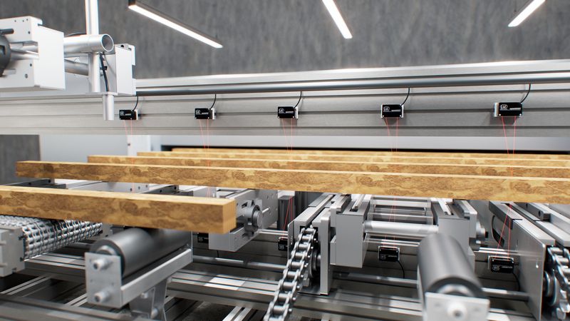 When measuring board contours in edging machines, Opto-NCDT 1220 laser sensors are mounted every 30 to 50 cm to measure the profile of the boards as they enter crosswise. Via IO-Link, the numerous sensors can be centrally integrated, uniquely assigned, and configured. (Source: Micro-Epsilon Messtechnik GmbH & Co. KG)