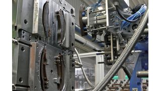 Blick in die 2K-Spritzgiessmaschine mit robotergestützter Entnahme. (Bild: Weiss)