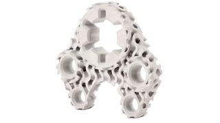 This machine bracket has been designed using a gyroid lattice infill and titanium in place of 17-4PH stainless steel to reduce weight and material while maintaining the required functional strength and stiffness. (Business Wire)