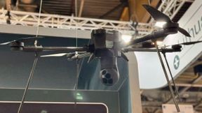 3D-printed plastic prototype of a payload mounted on a real-size drone, Eurosatory 2026 (Source: Tactical Photonics)