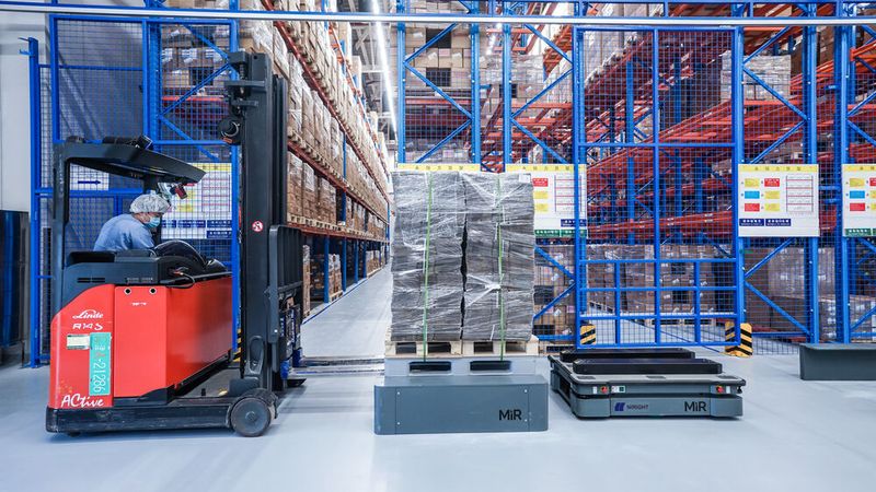 Die Roboter holen Verpackungsmaterial an der Warenannahme ab und bringen es ins Lager. Dort übernehmen Hochregalstapler und verfrachten das Material in die Regale. (Bild: Novo Nordisk)