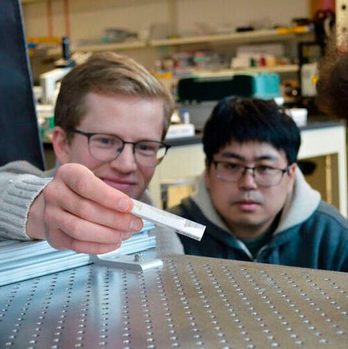 College of Science and Engineering students with the metamaterial object. College of Science and Engineering students with the metamaterial object.
