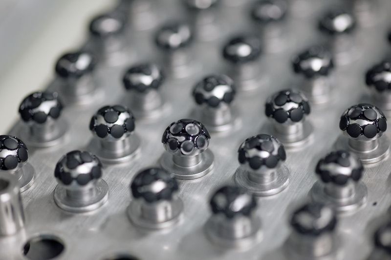 Um die Linsen schleifen zu können, müssen sie vorab auf den Halterungen mit Pech fixiert werden. (Zeiss)