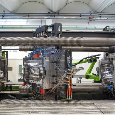A view into the mould area of the Engel duo 4000 combi M with 40000 kN clamping force. The turning-platen design allows several processes to be combined in a single mould, from film back-moulding to flooding with polyurethane. For processors, this means shorter process chains and lower unit costs in the production of large-format exterior components. (Source: Alessandro Cereda/ Engel)