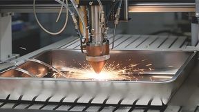 A close-up of a laser-directed energy deposition (LDED) system fabricating the novel AI-designed ultra-high strength steel, which achieves a rare balance of strength and ductility, excellent corrosion resistance, and requires only 6 hours of single-step heat treatment at low cost. (Source: Yating Luo et. al.)