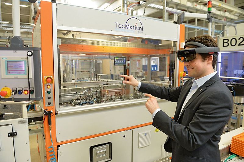 Nähert sich Patrick-Benjamin Bök der Spritzgussmaschine, legt sich in seiner Brille ein 3D-Modell in leuchtenden Umrissen über die reale Anlage. (Picture Alliance)
