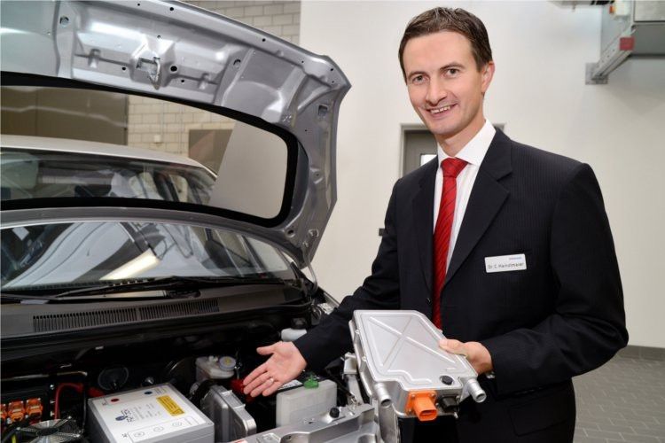 Dr. Christian Hainzlmaier, Projektleiter Hochvoltheizung bei Webasto, zeigt das Gerät und die Einbauposition im Fahrzeug. (Webasto)