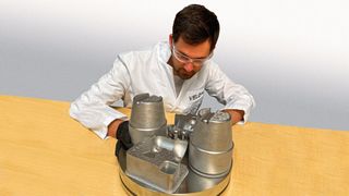 Engineer evaluating an M300 tool steel print of conformal cooled tooling and high pressure die casting inserts. These types of inserts are widely used to manufacture parts for the automotive industry. (Source: Business Wire)
