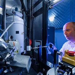 ORNL’s David Cullen stands in front of the new Thermo Scientific Spectra Ultra transmission electron microscope. (Source:  ORNL/ Carlos Jones, U.S. Dept. of Energy)