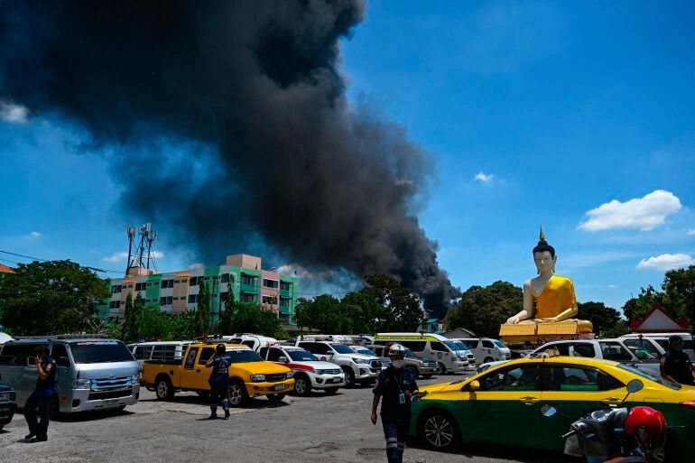 Thick black smoke billowed from the burning factory in Thailand after the fire was extinguished. (Lillian Suwanrumpha/ AFP)