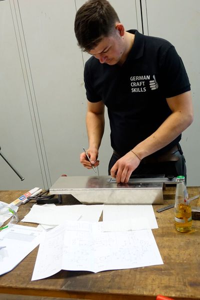 Luca Gerspacher (Karosserie- und Fahrzeugbautechnik) beim exakten Anreißen der entsprechenden Maße. (Bild: Dominsky – VCG)