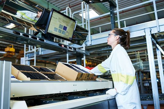 (Das Ware-zur-Person-Prinzip optimiert die manuelle Kommissionierung: Die Waren stehen in ergonomischer Höhe zur Verfügung. Übersichtliche Bedienoberflächen optimieren die Qualität. Jeder Artikel muss für die Kommissionierung nur einmal berührt werden. Die Mitarbeiter übergeben die Artikel vom Quellkarton an die Versandkartons. (Bild: Knapp))