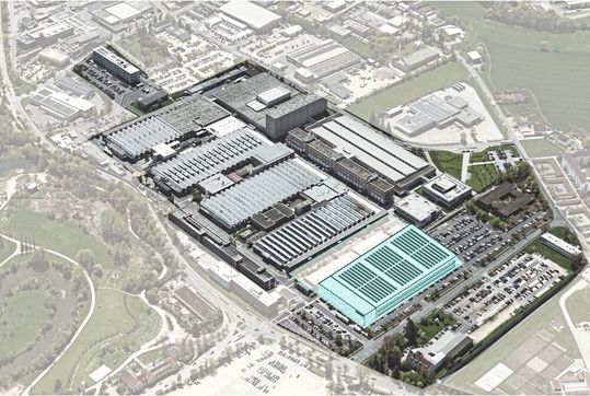 The picture shows an aerial view of the existing site, supplemented by a visualization of the Smart Factory. The new production facility is to be built on the current parking lot.(Image: Siemens AG)