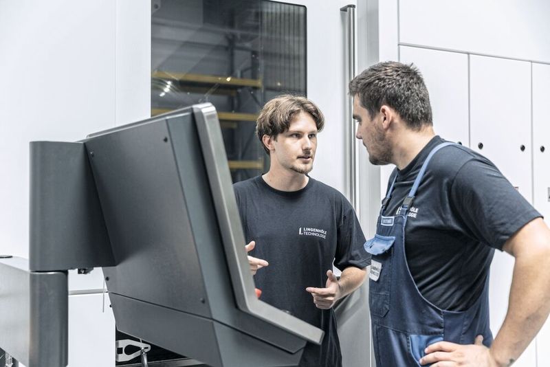 Die verantwortlichen Maschinenbediener Nico Brunnflicker (links) und Michael Bestebener halten das fünfachsige Fräs-Dreh-Zentrum «F 6000» von Heller rund um die Uhr am Laufen. Besonders begeistert sind sie von der benutzerfreundlichen Bedienung. (Bild: Heller)