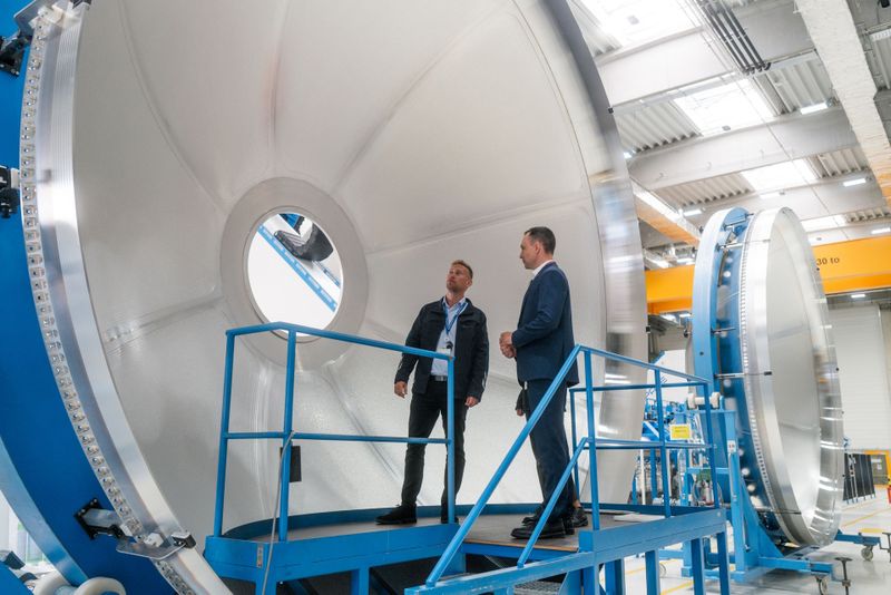Benedikt Gundling und Tobias Hannen vor einer Tankkomponente der Ariane 6.   (Bild: GROB-WERKE GmbH & Co. KG)