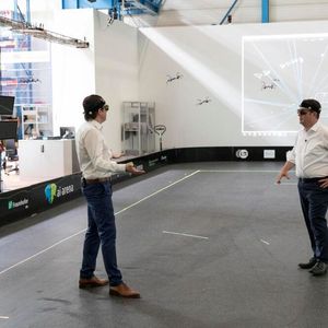 Doch der Test mit dem Exoskelett war nicht alles, was Bundesarbeitsminister Hubert Heil bei seinem Besuch am Fraunhofer IML an smarter Technik erlebte. Hier steuert er einen Schwarm aus 20 Drohnen, die dabei das Verhalten von Vögeln imitieren.(Bild:  Fraunhofer IML)