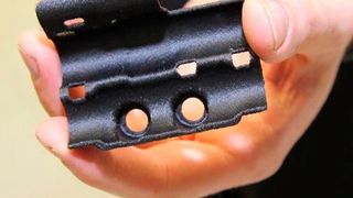 A hydraulic line bracket for the McLaren MCL32 race car, 3D-printed on a Stratasys FDM 3D printer using Nylon12CF material. (Stratasys)