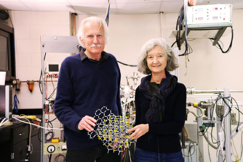 Walter de Heer and Claire Berger, physics professors, holding an atomic model of graphene (black atoms) on crystalline silicon carbide (yellow atoms) in the Epitaxial Graphene Lab at Georgia Tech. (Source: Jess Hunt-Ralston, Georgia Tech)