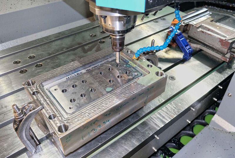 Close-up of the tool, comprising a bolster and a hardened, 12-impression insert for making test tubes. (Hurco)