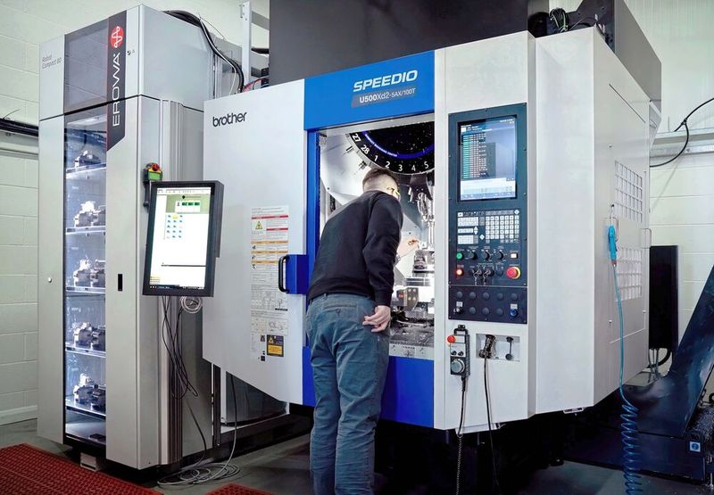 Dominic Roach with the new Brother Speedio U500Xd2-100T automated production cell. (Source: Whitehouse Machine Tools )