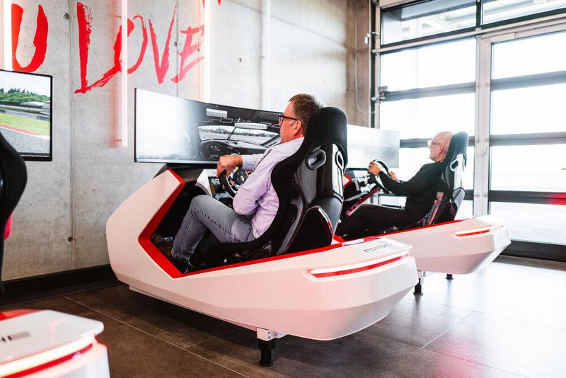 Nach dem Sicherheitstraining versuchen sich Gregor Großmann (l., G-Bit) und Stephan Klahr (GoTo) zunächst am Porsche-Simulator. (Bild: GoTo Technologies Germany)