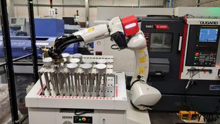 The robot is picking a new billet for machining. (Source: Empire Manufacturing)