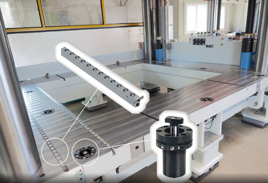 Hydraulic double-acting swivel-clamping elements are used on the press table. Their design eliminates any edge interferences that could hinder the insertion of tools. To facilitate the insertion and removal of heavy tools, transport rails have also been integrated into the surface of the table.(Source:  Roemheld)
