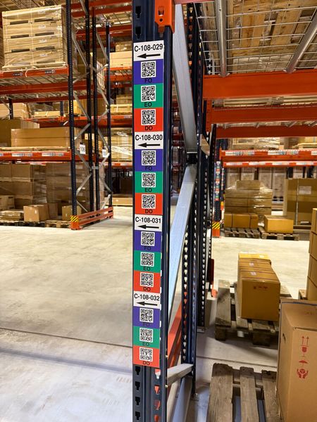 An den Regaldurchfahrten erleichtern Farbcodes für die verschiedenen Ebenen und Richtungspfeile auf den Man-down-Etiketten den Mitarbeitern die eindeutige Zuordnung. Das steigert die Prozesssicherheit und Produktivität. Um der hohen Beanspruchung standzuhalten, hat ONK diese Etiketten aus widerstandsfähigem PVC-Hartschaum zugeschnitten und bedruckt. (Bild: Yusen Logistics)