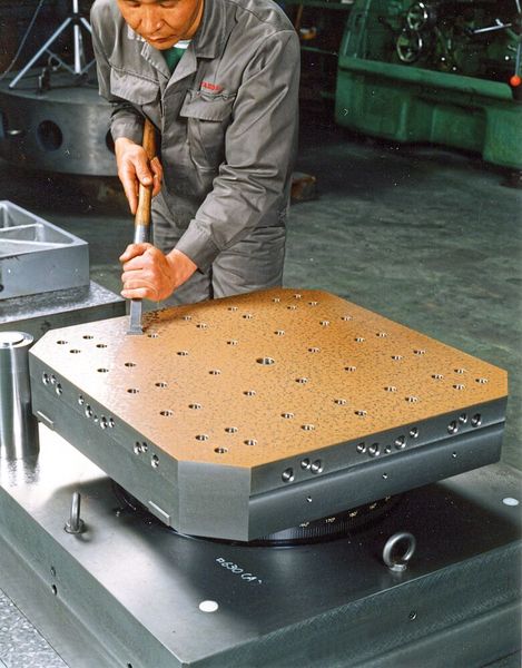 Die Paletten werden auf einer Masterstation hydraulisch geklemmt und handgeschabt. (Yasda)