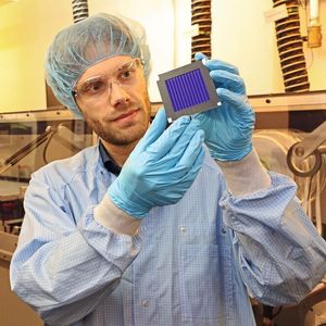Dr. Andreas Distler (ZAE Bayern) mit dem organischen Rekord-Solarmodul in der Solarfabrik der Zukunft. Im Hintergrund die Pilotlinie für gedruckte Dünnschichtphotovoltaik.